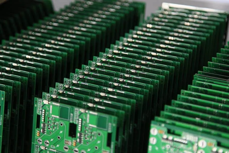 A large quantity of PCBs stacked after mass production.