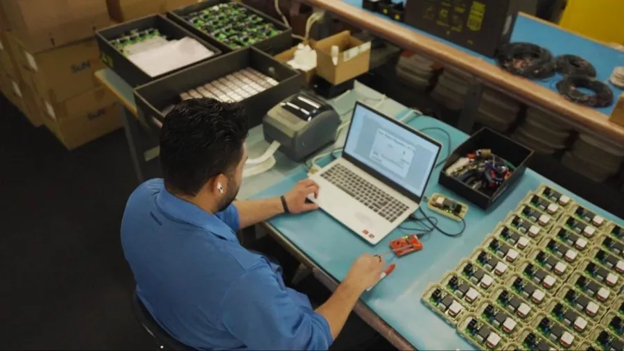 A PCB design engineer working on a computer with PCB design software.