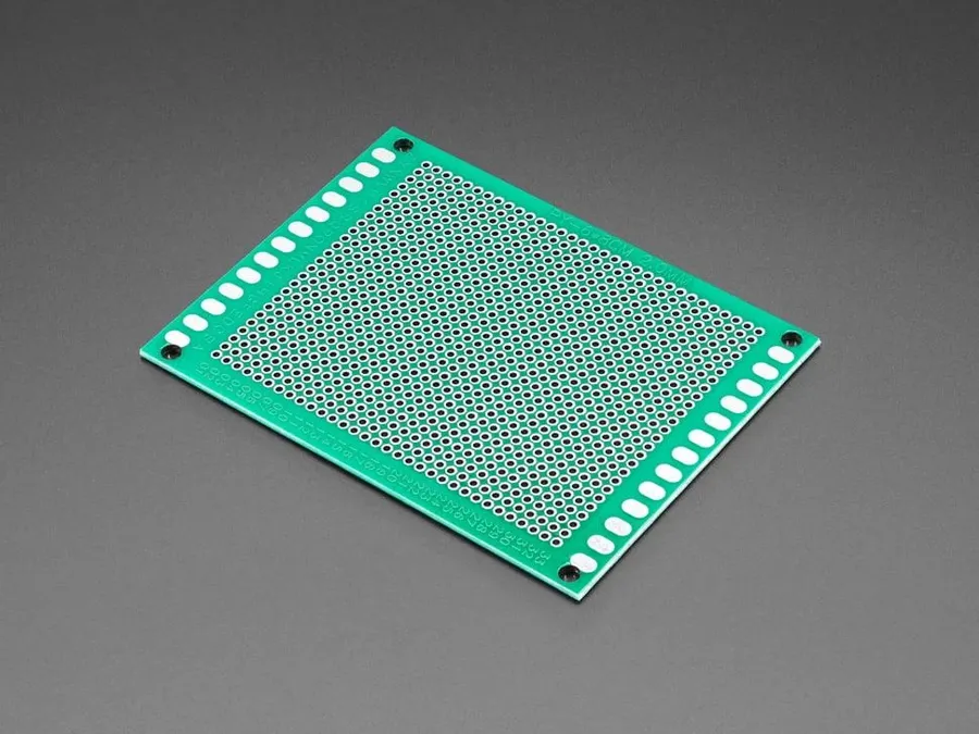 A bare PCB prototype board.