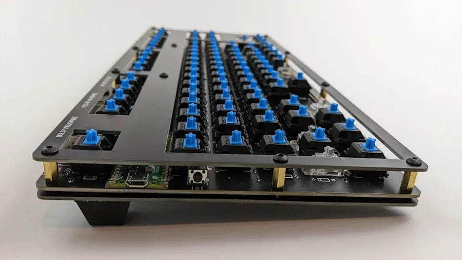 A panel of keyboard PCBs being manufactured in a factory.