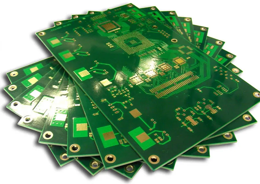 A manufacturing facility with equipment for PCB production, showing various processes in action.
