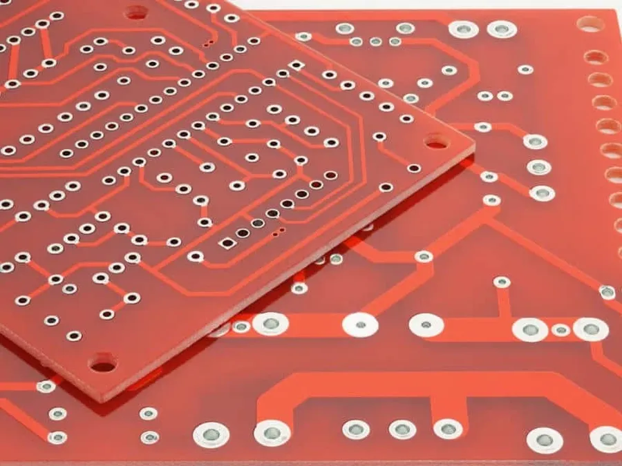 A technician inspecting a single layer PCB using a microscope.
