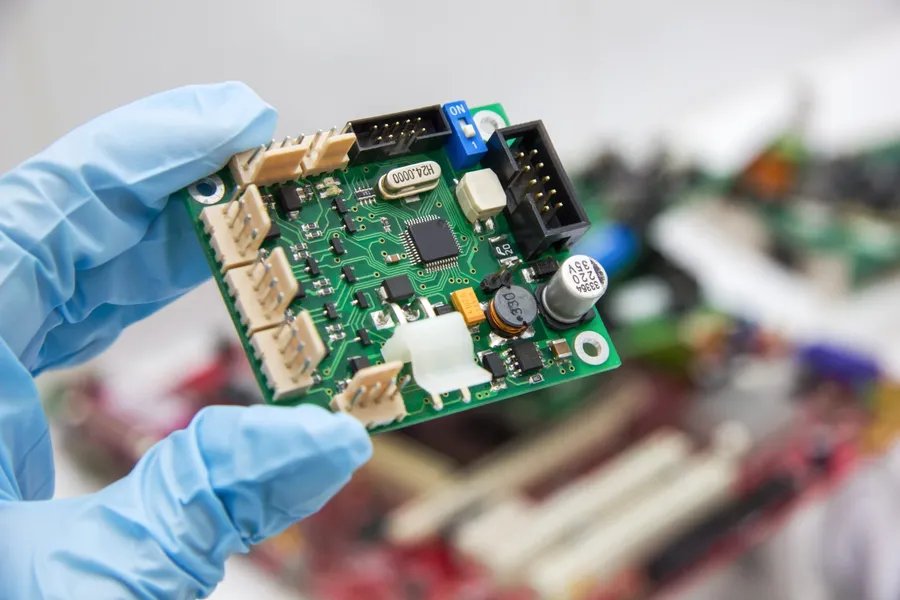 A bare printed circuit board with visible traces and pads.