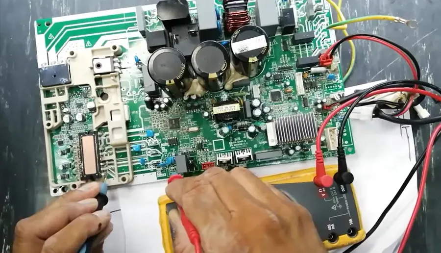 Hands replacing an air conditioner PCB board.