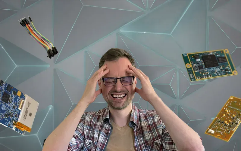 An engineer holding a PCB prototype board in a lab