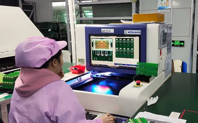 An engineer operating PCB testing equipment